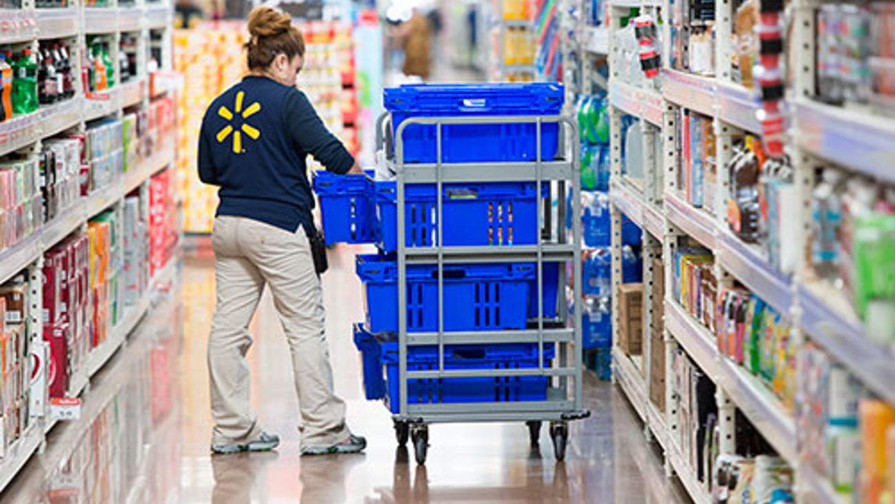 Walmart employee stocking shelf