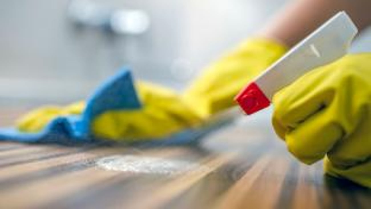 Person spraying table