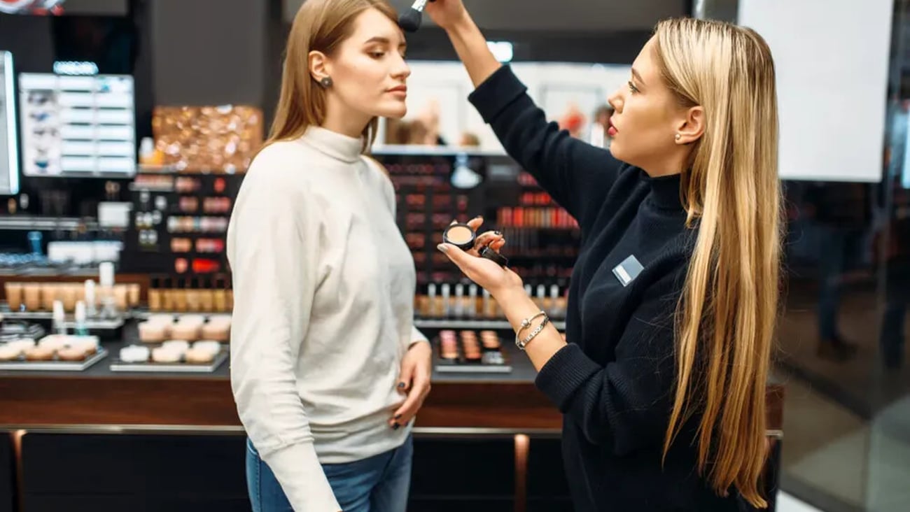 Seller and woman testing powder in make-up shop; Shutterstock ID 1399323866