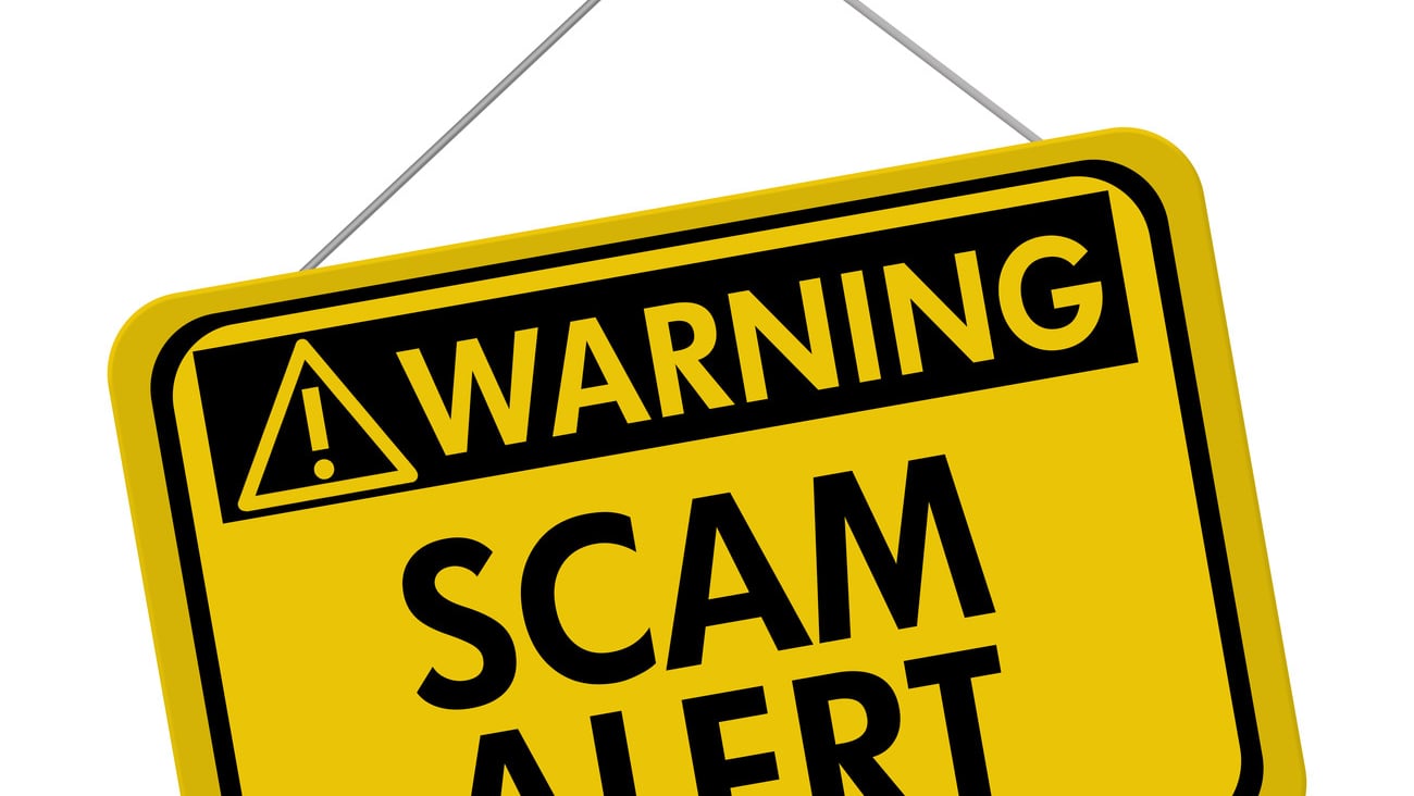 A yellow and black sign with the words Scam Alert isolated on a white background, Warning of Scam Alert; Shutterstock ID 155271245