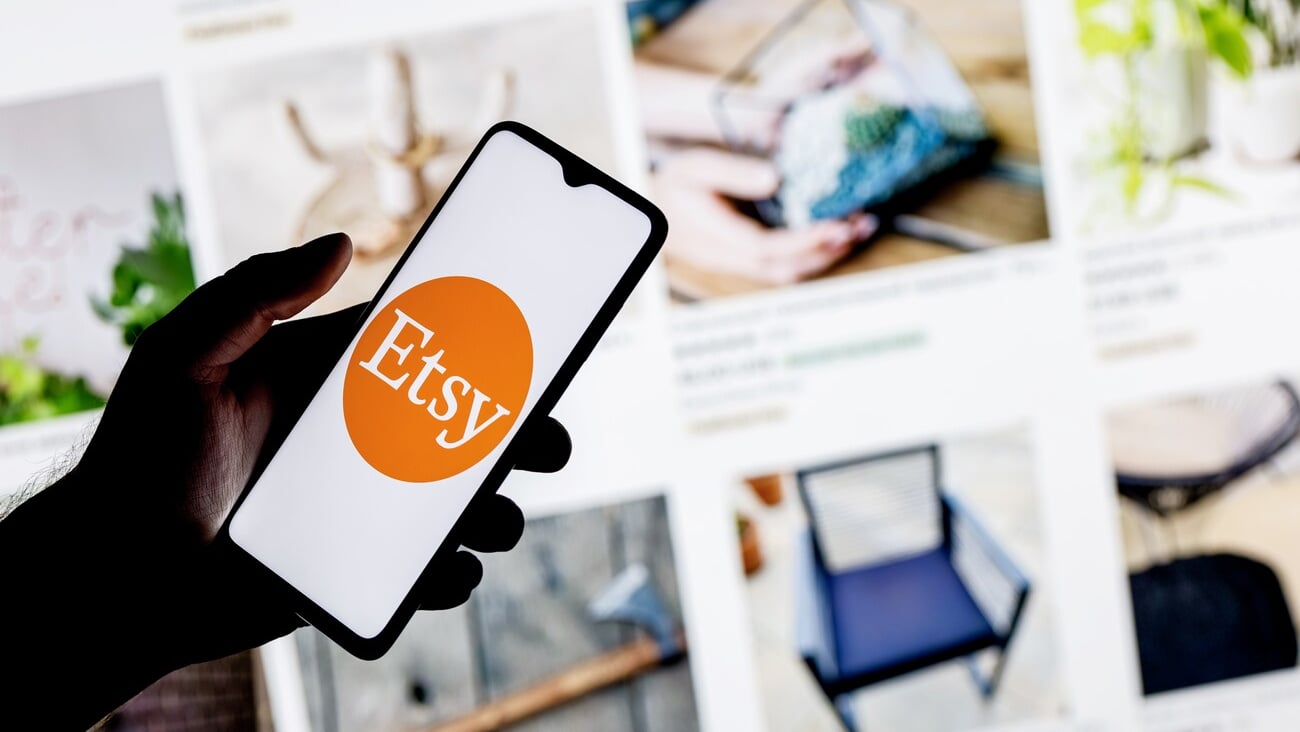 Kazan, Russia - Oct 6, 2021: Etsy is American e-commerce company focused on handmade items and craft supplies. A smartphone with the Etsy logo in a hand.; Shutterstock ID 2053217924