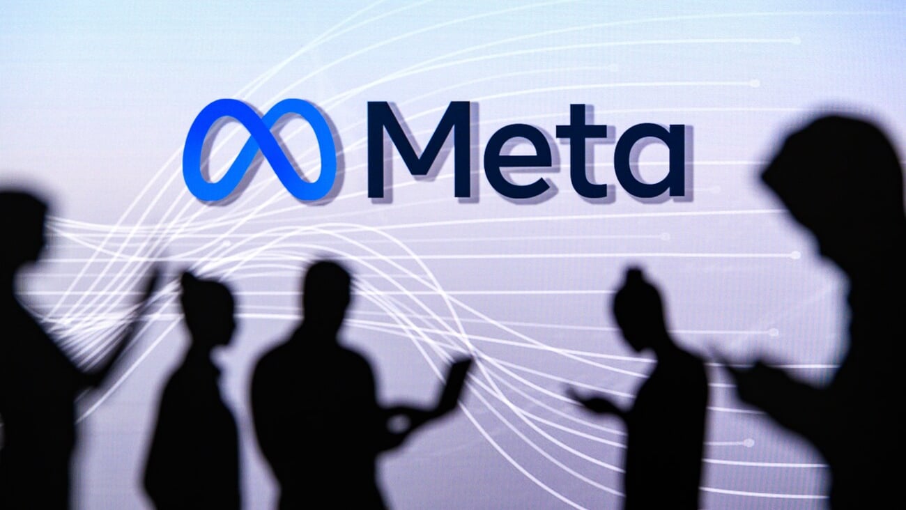 NEW YORK, USA, 1. MARCH 2022: Meta or Metaverse logo on big screen, Facebook company, Meta Platforms. business and employment-oriented online service Group of business people chat on phone and laptop; Shutterstock ID 2131709785