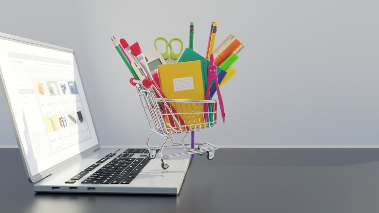 School supply online shopping and sale. Office stationery in a shopping cart on a computer laptop, copy space. 3d render; Shutterstock ID 2227097479