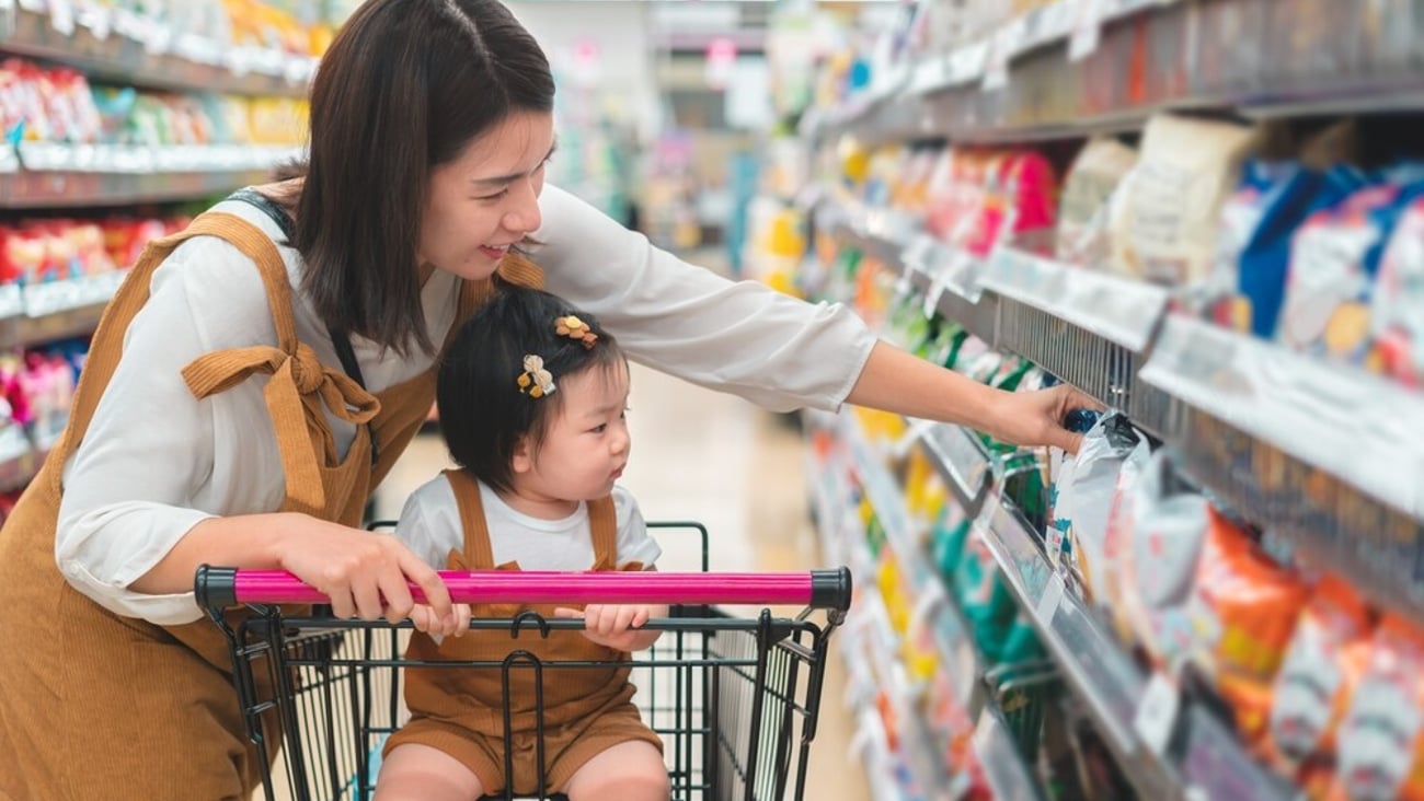 Asian mother and her daughter buying food at huge supermarket , Baby sit in trolley, Family shopping concept.; Shutterstock ID 2294167151