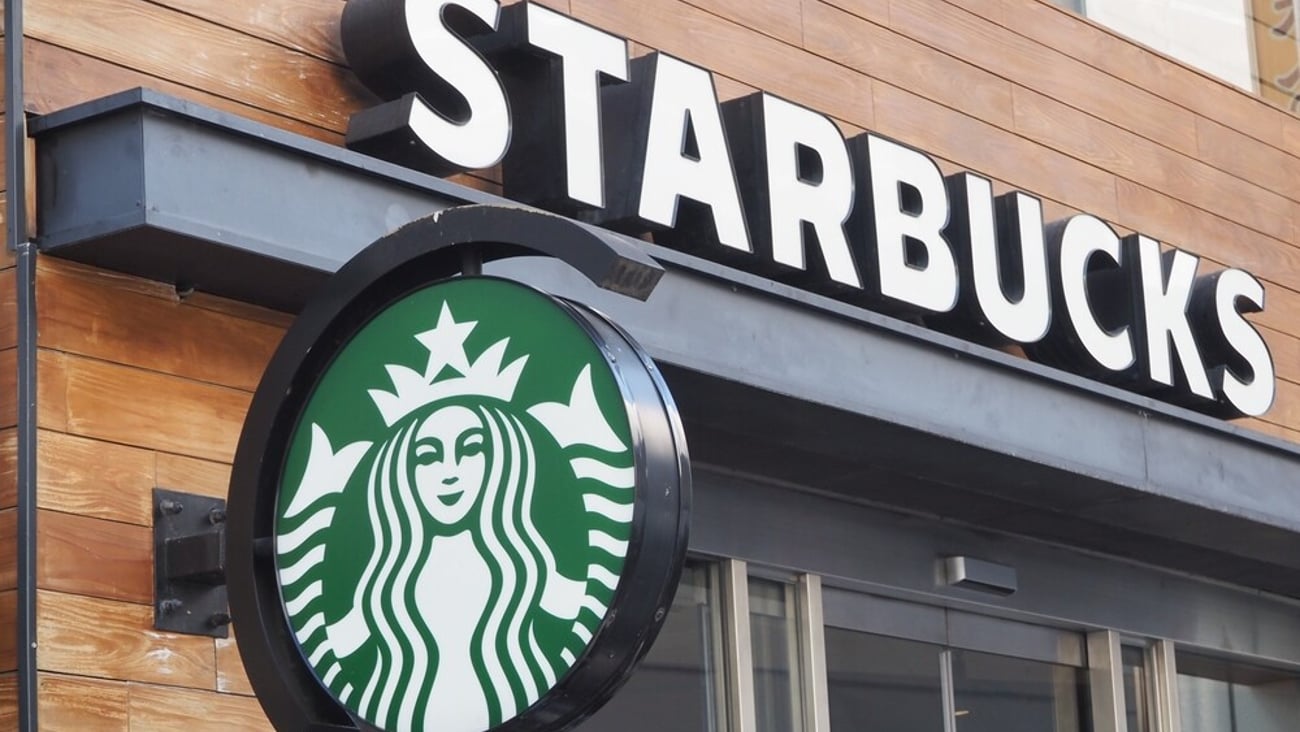 TOKYO, JAPAN - February 11, 2024: Signs on a Starbucks branch in Tokyo's Shibuya area.; Shutterstock ID 2424822809