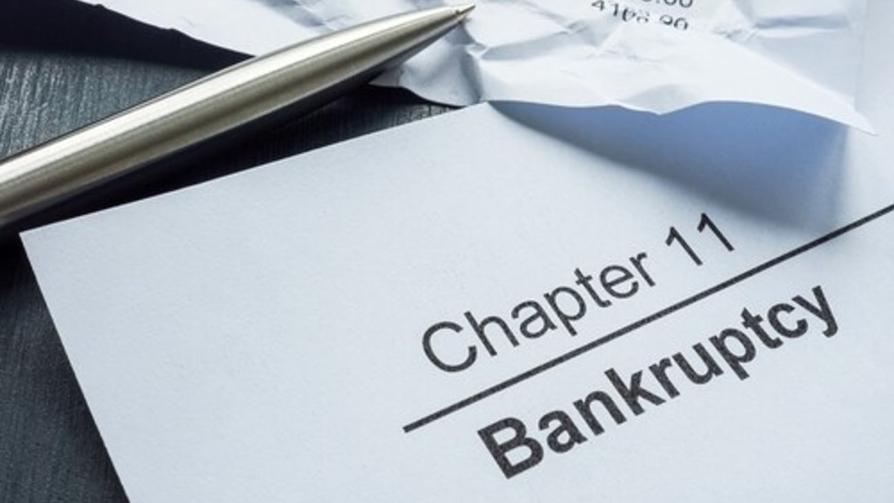 Chapter 11 bankruptcy and crumpled financial statement.; Shutterstock ID 2439174953