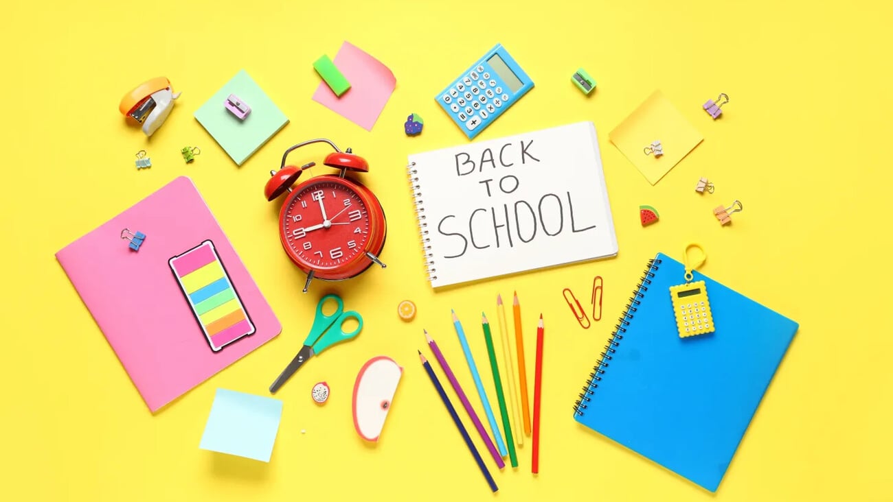 Alarm clock, notebook with text BACK TO SCHOOL and different stationery on yellow background; Shutterstock ID 2483972281