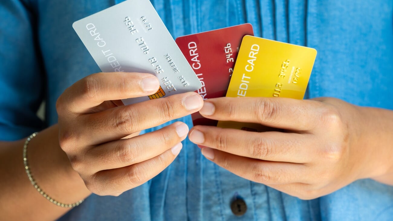 Man holding several credit cards and he is choosing a credit card to pay and spend Payment for goods via credit card. Finance and banking concept.; Shutterstock ID 2519003035