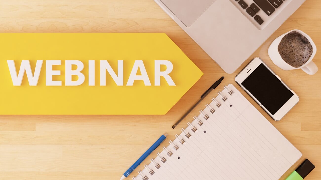 Webinar - linear text arrow concept with notebook, smartphone, pens and coffee mug on desktop.; Shutterstock ID 400993198