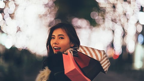 Woman holding holiday shopping bags