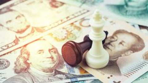 Chinese and American money with chess pieces