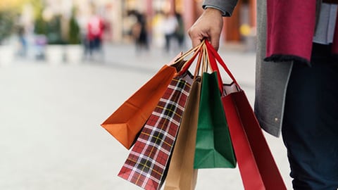 man holding shopping bags