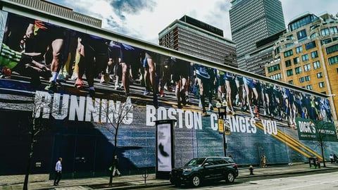 A banner with the tagline "Running Boston Changes You" has been placed on the future location of Dick’s House of Sport in Boston.
