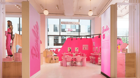 Selfridges' London flagship features exclusive Barbie-inspired activations, including storefront windows that display official movie costumes.