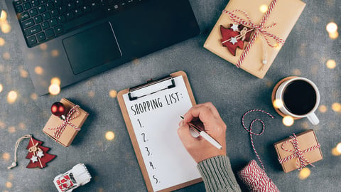 Christmas online shopping flat lay. Girl writing shopping list. Laptop, present box, cup of coffee, holiday decoration. Winter holidays sales; Shutterstock ID 1816989257