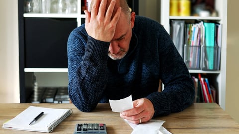 Man upset headache depressed from family cost got higher doing accounting holding receipts from supermarket with calculator by rising grocery prices and surging cost as an inflation financial crisis.; Shutterstock ID 2131821733