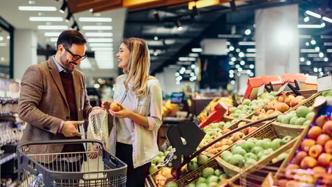 Cheerful couple choosing fruit at groceries department of the supermarket. Man holding mesh bag and woman holding fruits. Shopping at the modern mall; Shutterstock ID 2159860109