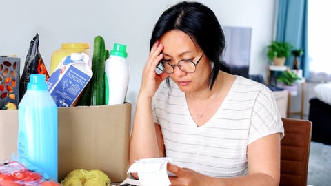 Living cost inflation crisis high cost in gas electric energy woman holding receipts from supermarket with calculator by rising grocery prices and surging cost as an inflation financial crisis.; Shutterstock ID 2162437299