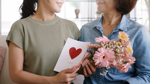 May Mother's day young adult grown up child cuddle hug give flower gift box red heart card to mature middle aged mum. Love kiss care mom asia people sitting at home sofa happy smile enjoy family time.; Shutterstock ID 2274179829