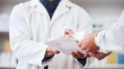 Healthcare, pharmacy and prescription medicine in hand of customer with paper, box or rx medication. Closeup of pharmacist or medical staff with person for pharmaceutical product at retail drugstore; Shutterstock ID 2353169745