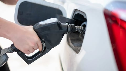 Female worker hand holding nozzle fuel fill oil into car tank at pump gas station, For the concept transportation power business technology concept; Shutterstock ID 2428860553