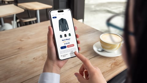 Woman shops for men's blazer on smartphone. Modern ecommerce app interface concept for effortless browsing and purchasing of stylish clothing; Shutterstock ID 2456075197