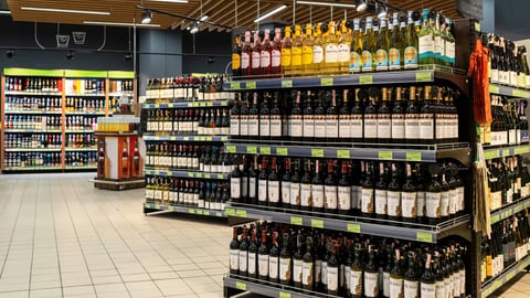 An assortment of imported wine and hard liquor bottles display neatly on store shelves. Alcohol retail business. Minsk, Belarus - July 8, 2024; Shutterstock ID 2486159995