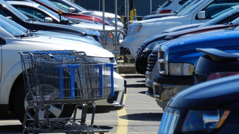 Shopping cart on a parking lot with cars; Shutterstock ID 622783607