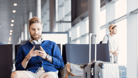 Consumer on mobile phone at airport