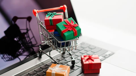 Black friday mini shopping bags in cart on the keyboard Online shopping ideas and home delivery services during the holidays.; Shutterstock ID 2055504500