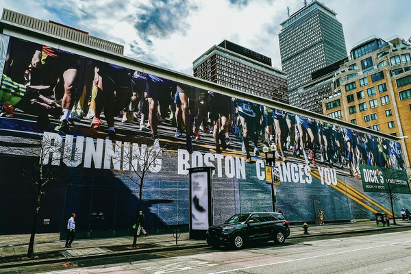 A banner with the tagline "Running Boston Changes You" has been placed on the future location of Dick’s House of Sport in Boston.