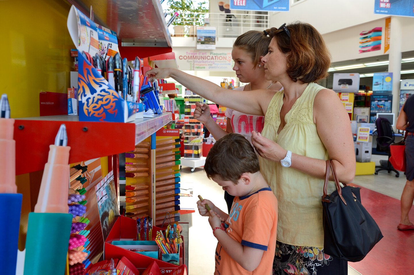 Back to school season. Purchase of school supplies in a stationery store with parents. Mother and daughter. Normandy, France, September 2013; Shutterstock ID 1495955075
