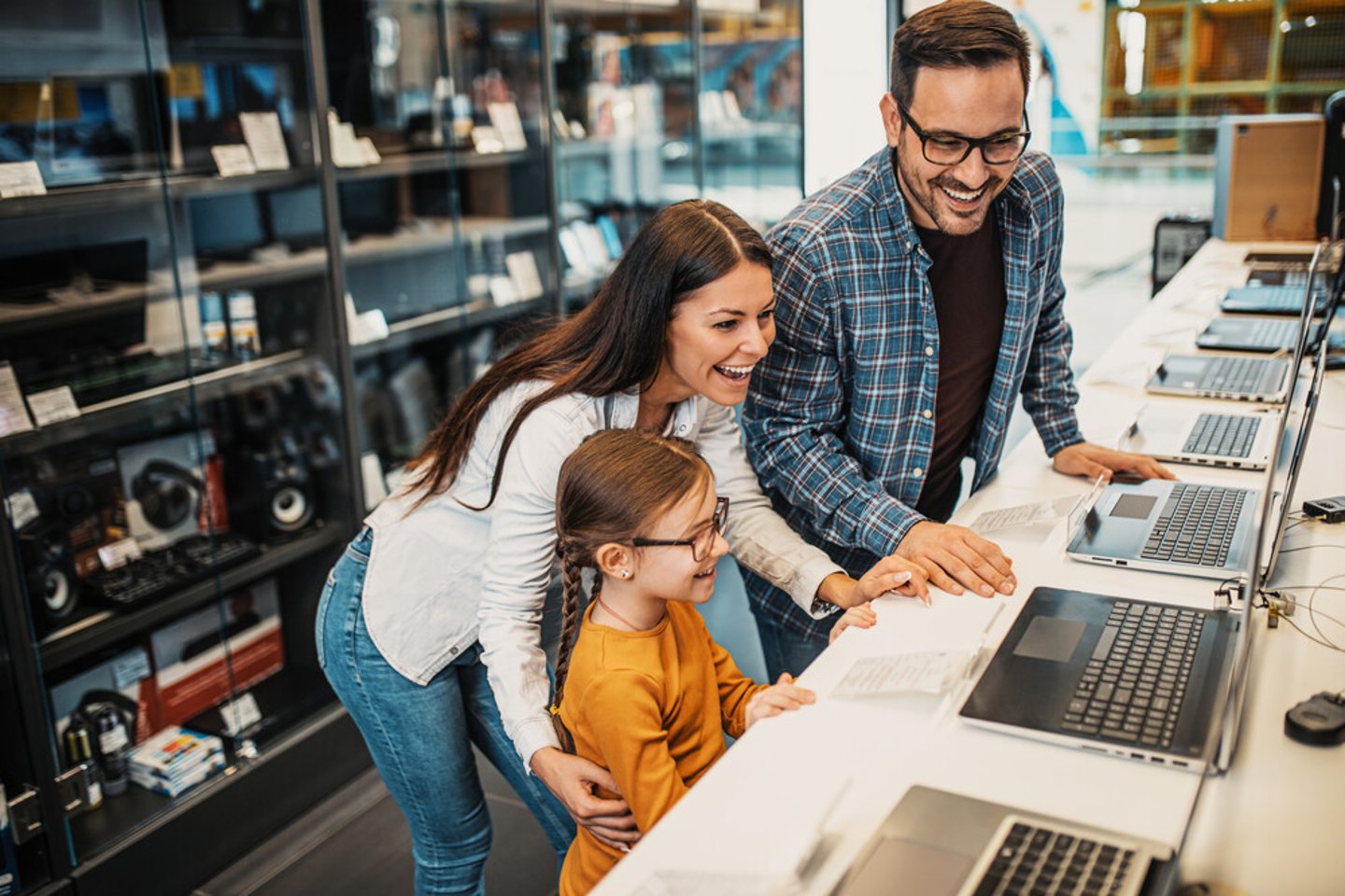 Happy family buying laptop in store.; Shutterstock ID 1841450527