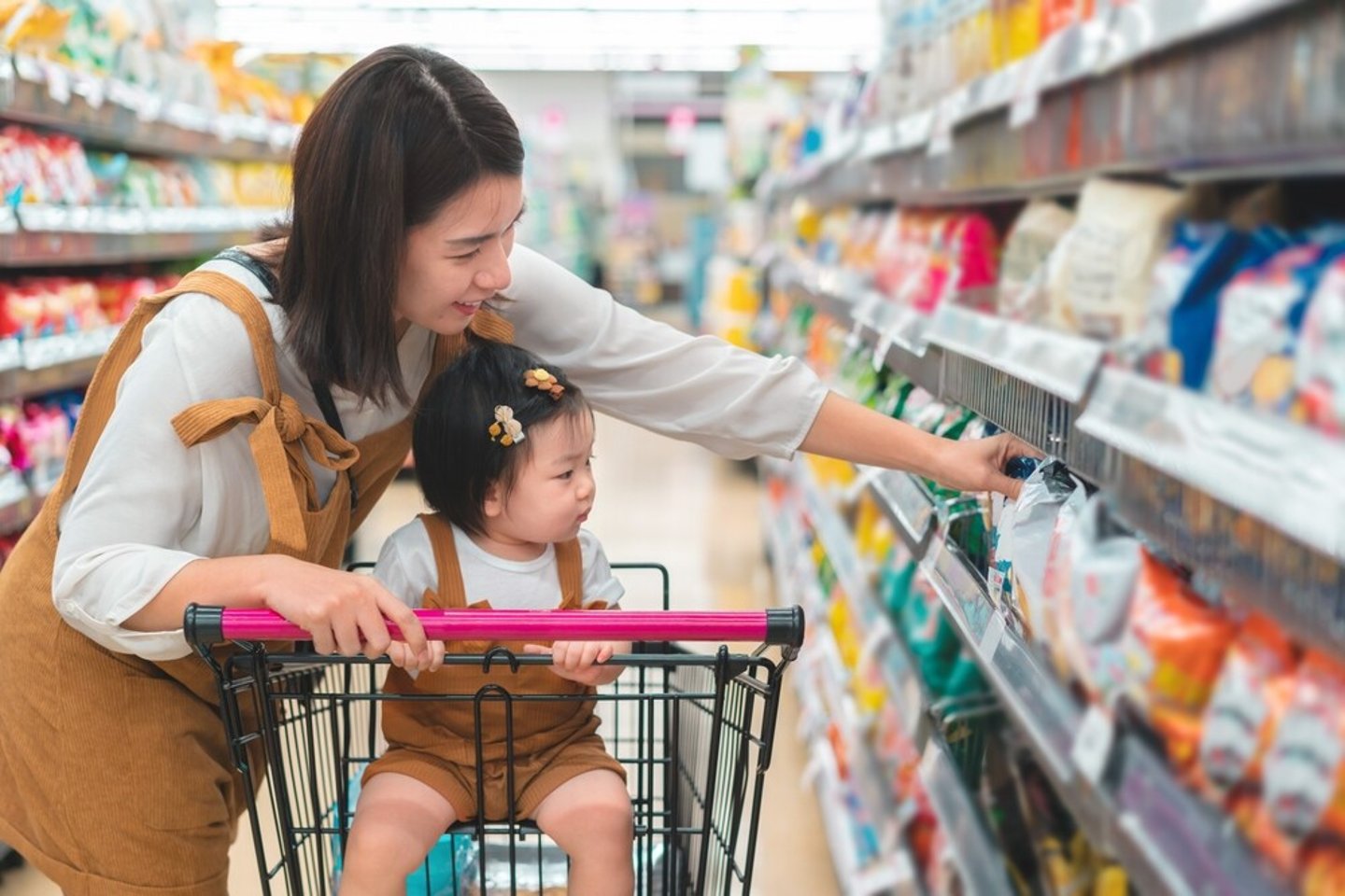 Asian mother and her daughter buying food at huge supermarket , Baby sit in trolley, Family shopping concept.; Shutterstock ID 2294167151