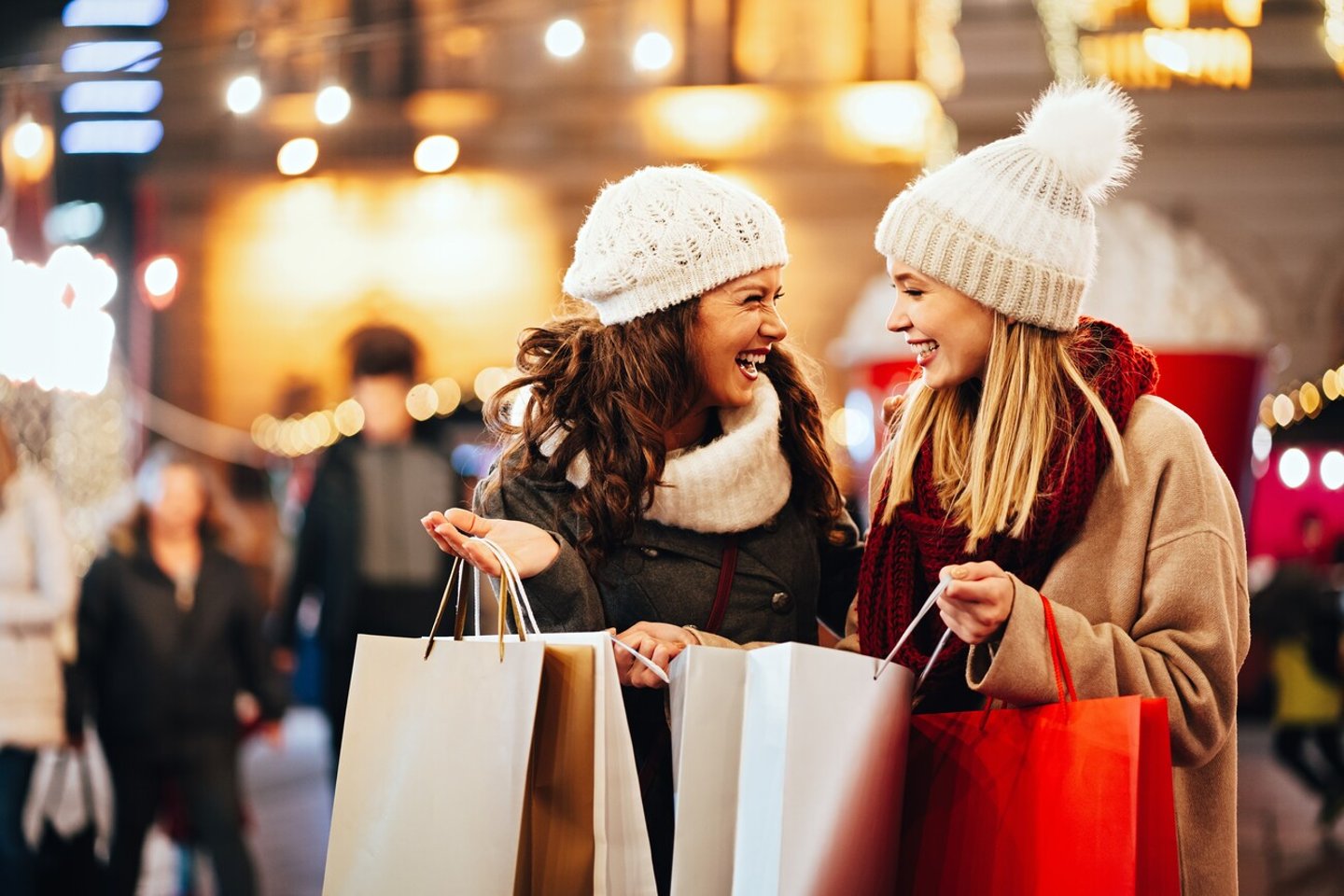 Happy women friends are shopping for presents at Christmas. People holiday sale shopping concept; Shutterstock ID 2376030343