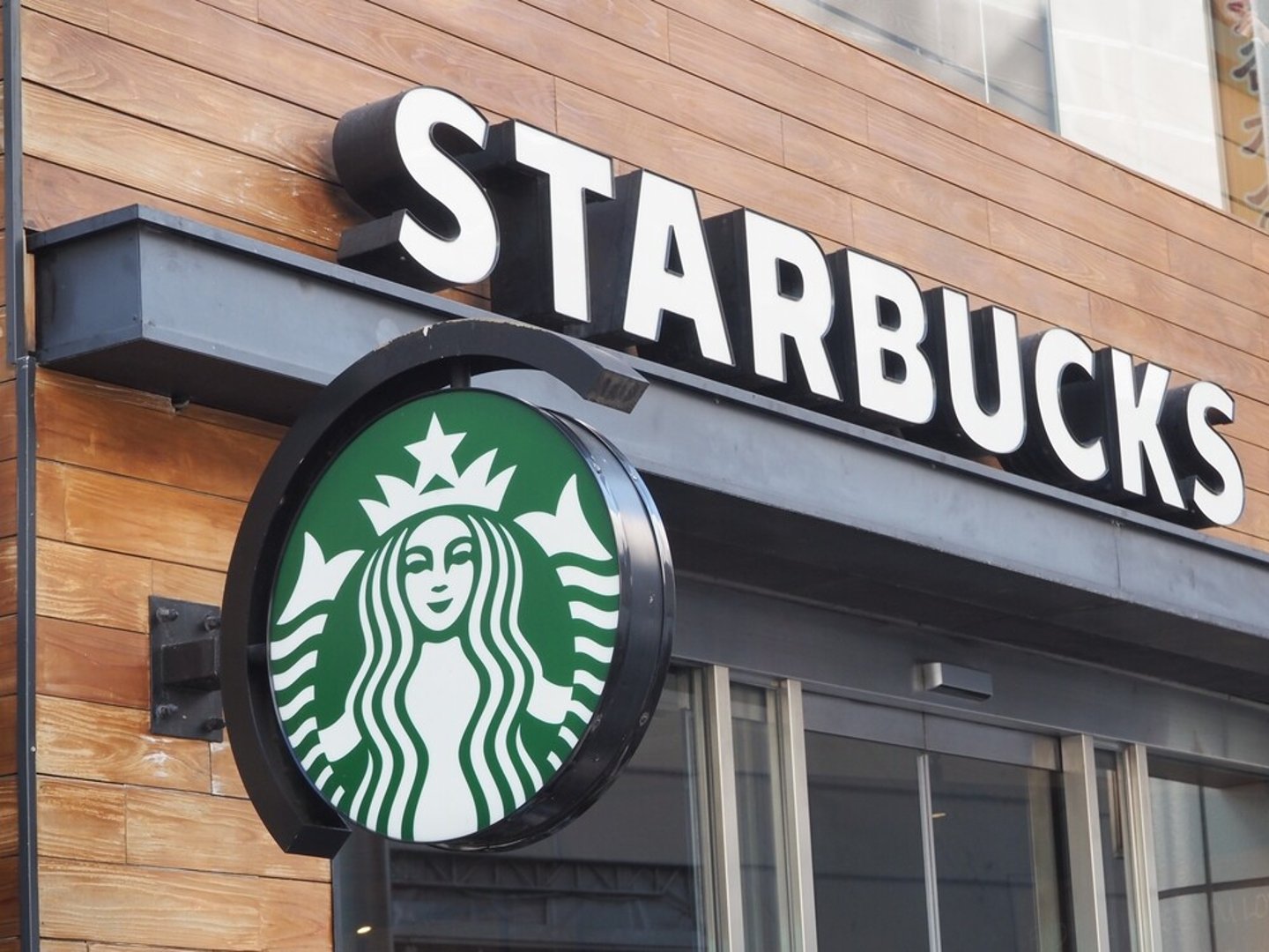 TOKYO, JAPAN - February 11, 2024: Signs on a Starbucks branch in Tokyo's Shibuya area.; Shutterstock ID 2424822809