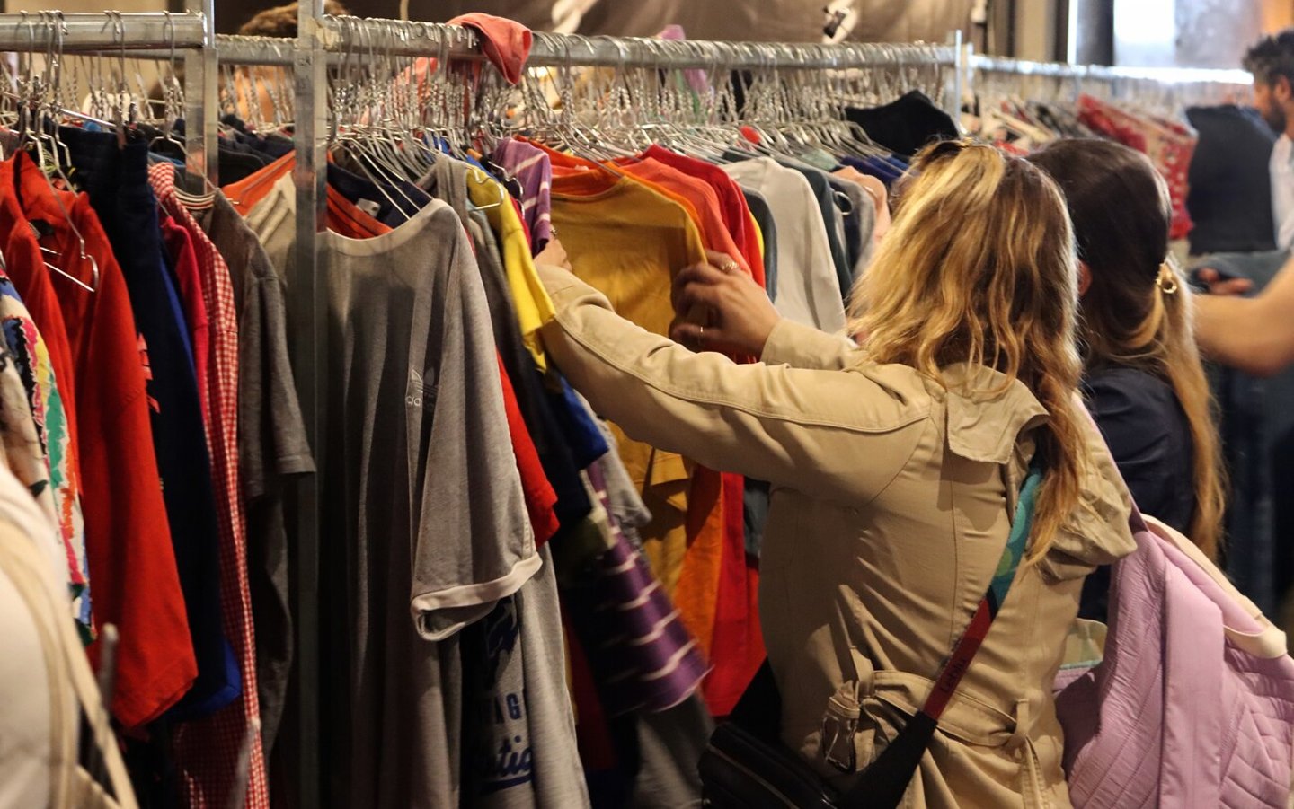 People buy vintage and second-hand clothes at a KiloShop. Clothing store, fashion. Puglia, Italy 01.06.2024; Shutterstock ID 2469752555