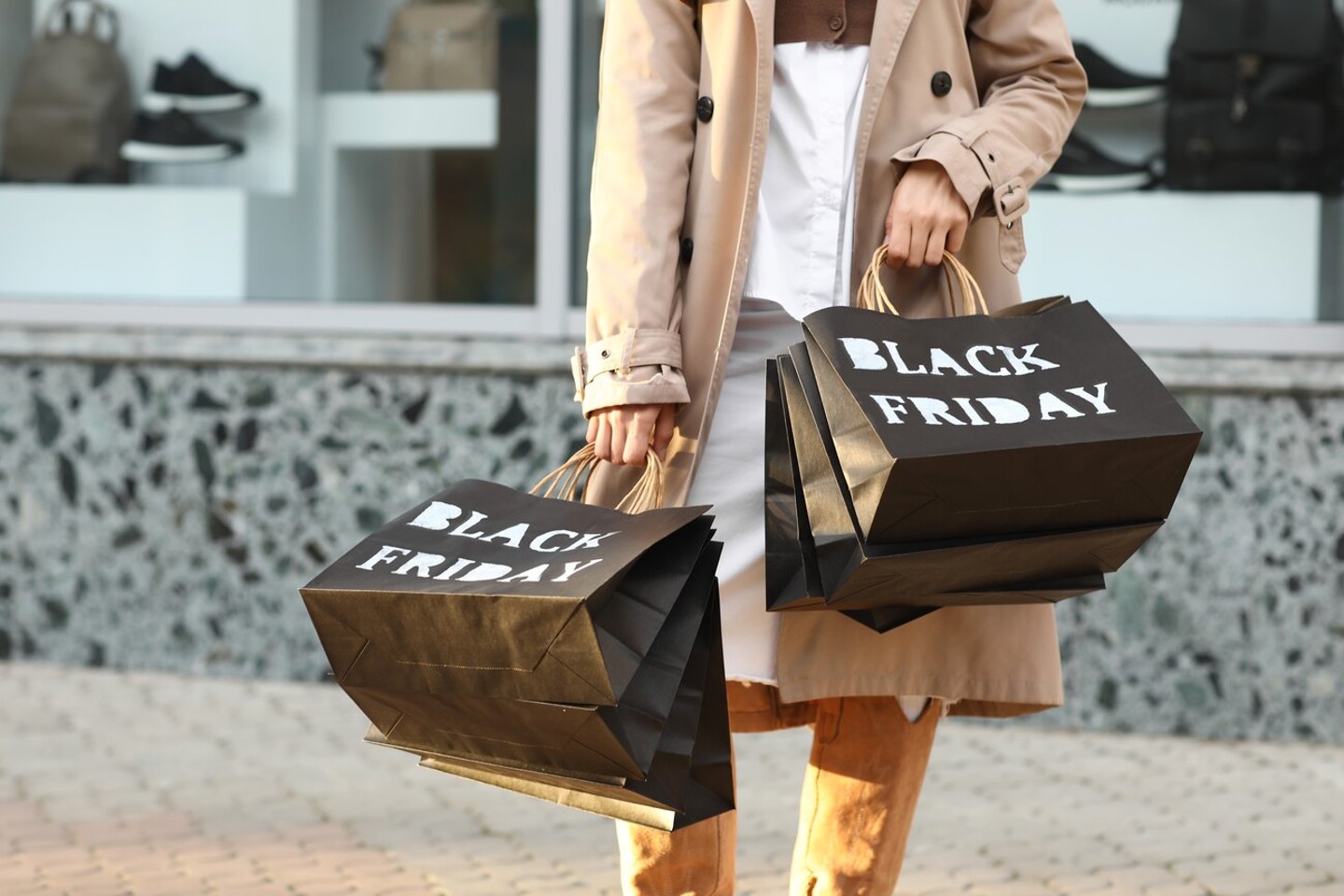 Beautiful young woman with shopping bags on city street, closeup. Black Friday sale; Shutterstock ID 2527885251