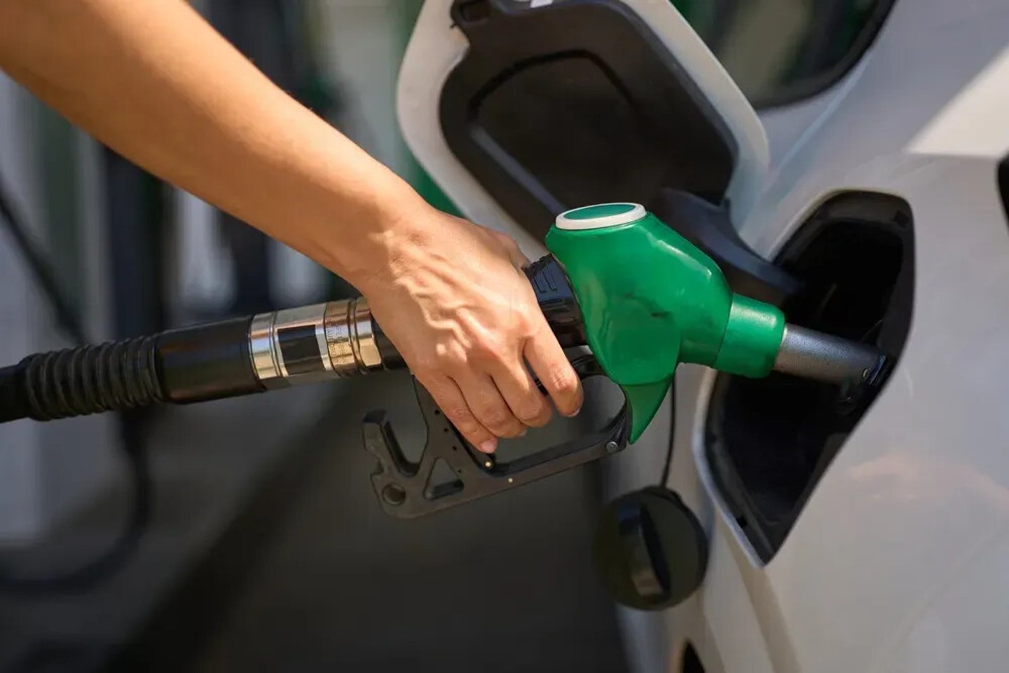Driver pumping gasoline fuel in car at gas station - fuel and oil price raise crisis; Shutterstock ID 2642543749