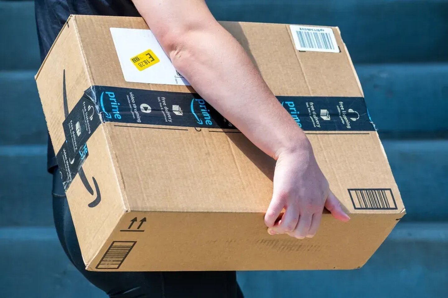 Salt Lake City, Utah, USA — September 1, 2025: An Amazon Flex driver delivers a large cardboard box to a residential doorstep. ; Shutterstock ID 2673275375