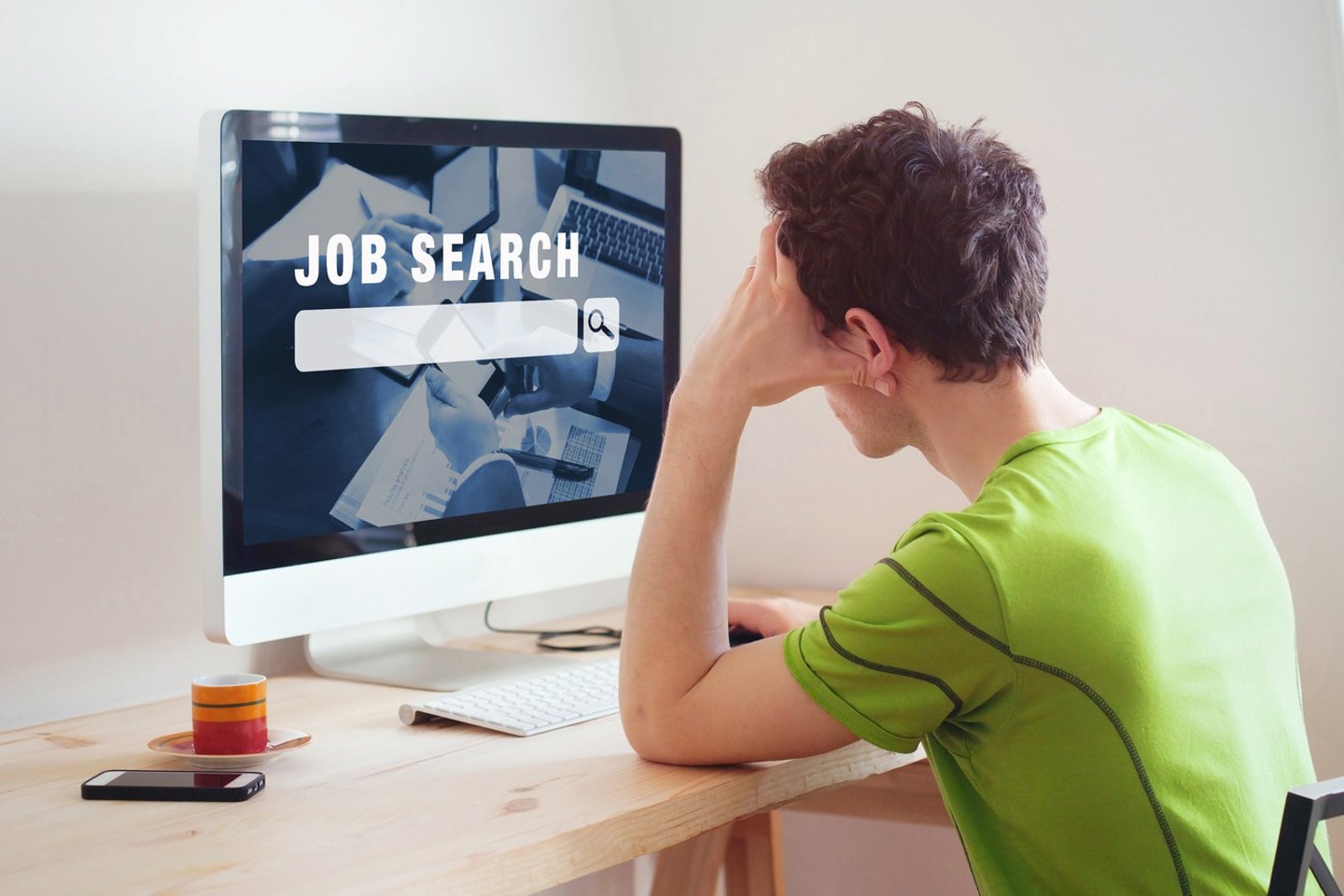 unemployment concept, job search on internet, man at home looking for good career; Shutterstock ID 702065437