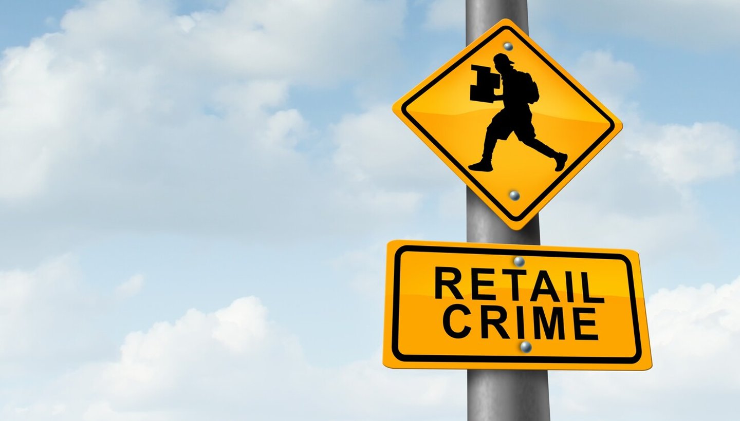 Retail crime theft problem robbing and shoplifting stores business concept of a shoplifter stealing merchandise from a retailer as a thief committing larceny with 3D illustration elements.; Shutterstock ID 2367504765