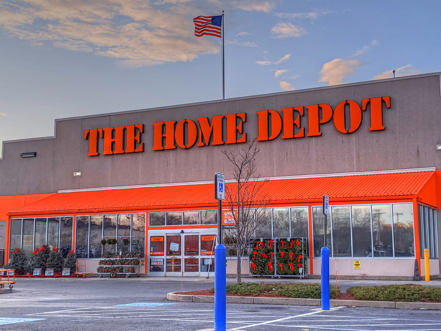 The Home Depot building supplier retailer, American flag waving above store sign, Chelsea Massachusetts USA, November 28, 2019; Shutterstock ID 1575365968