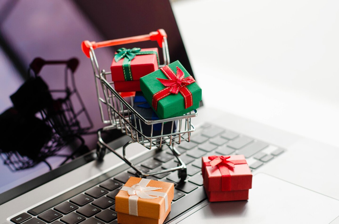 Black friday mini shopping bags in cart on the keyboard Online shopping ideas and home delivery services during the holidays.; Shutterstock ID 2055504500