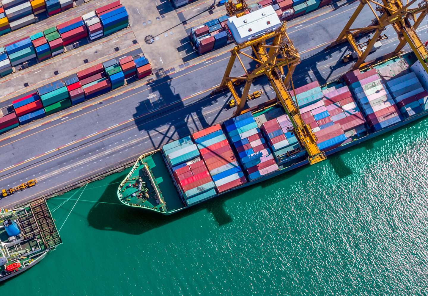 Logistics and transportation of Container Cargo ship and Cargo plane with working crane bridge in shipyard at sunrise, logistic import export and transport industry background; Shutterstock ID 779518414