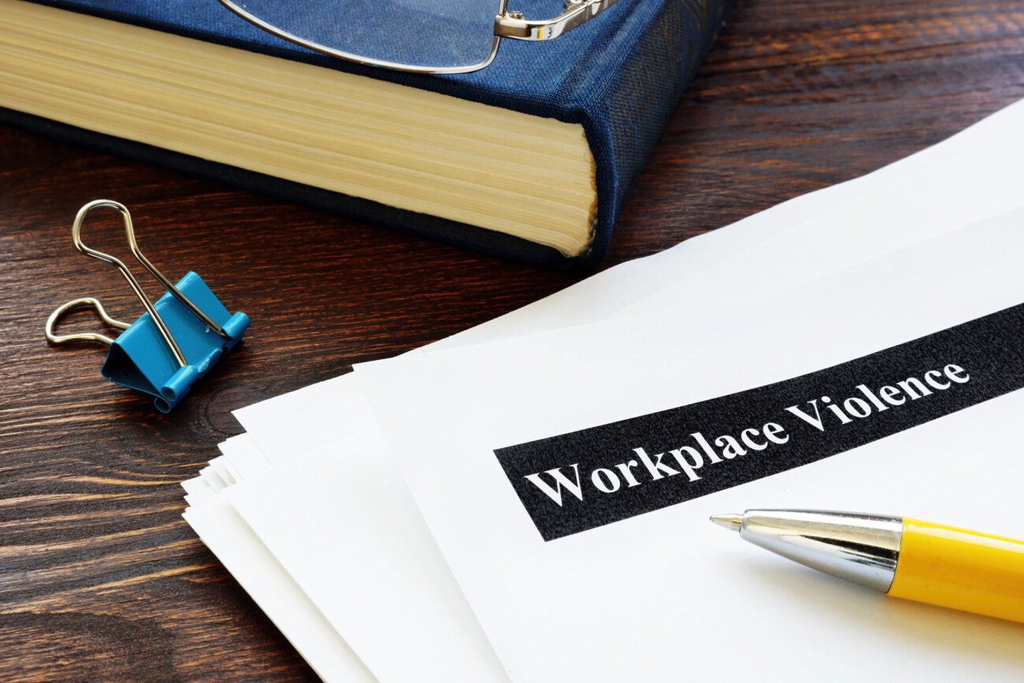 Workplace violence report papers and yellow pen.; Shutterstock ID 1819386968