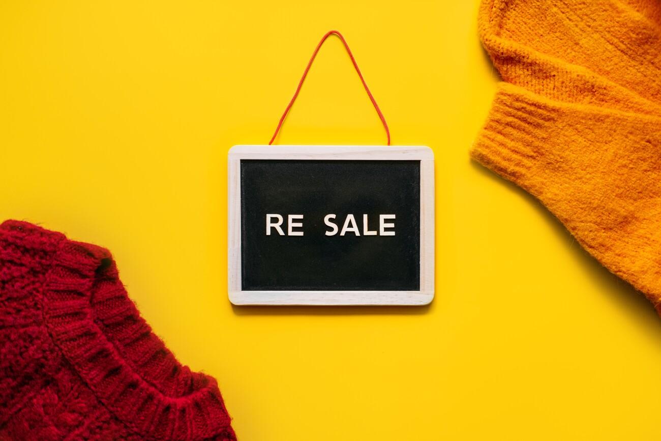 Resale-commerce, re-commerce, re sale concept. Buyback, Trade-In, and Upcycling in Retail. Circular economy. Word resale and clothing on yellow background; Shutterstock ID 2210048665