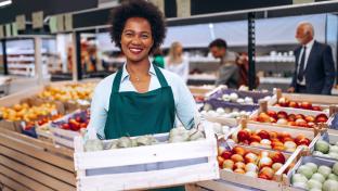 African American female employee working in grocery store.; Shutterstock ID 2180956731