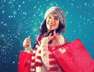 Woman in snow with shopping bags