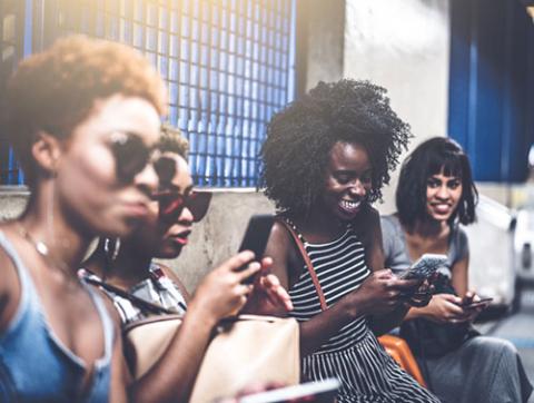 women using social media on mobile devices
